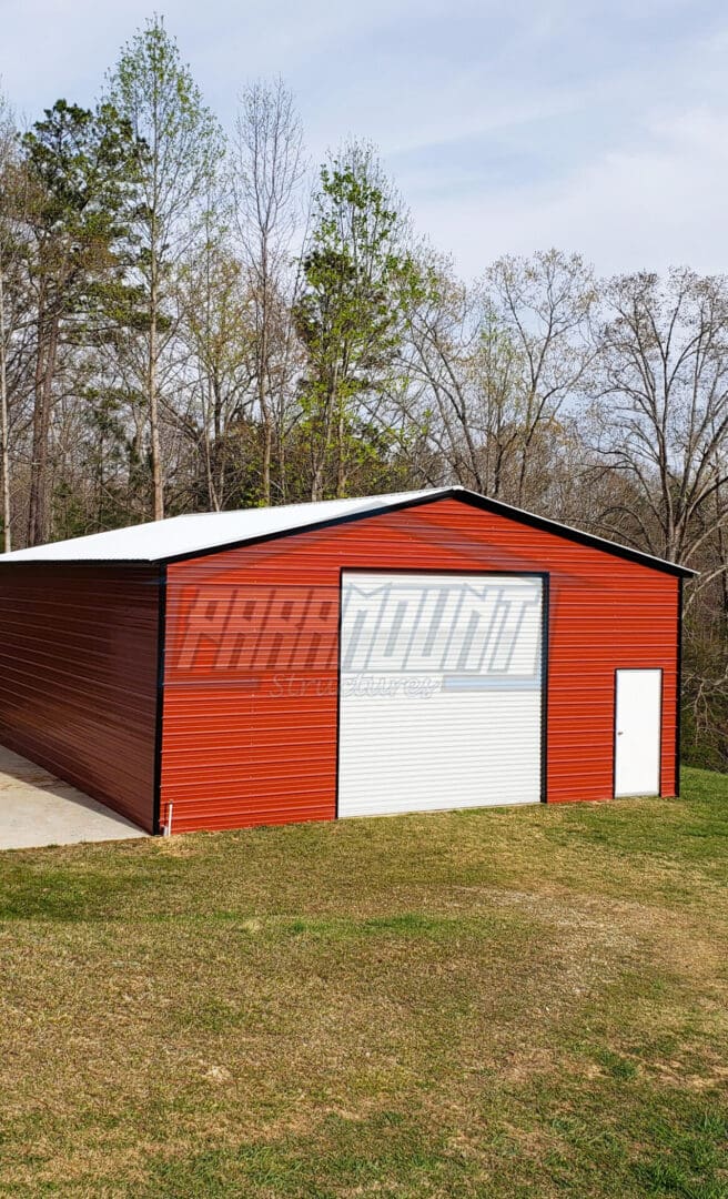 Red metal building with white trim and a white garage door.