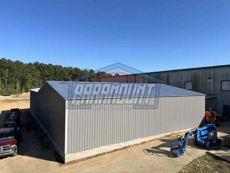 Gray metal building with white trim.