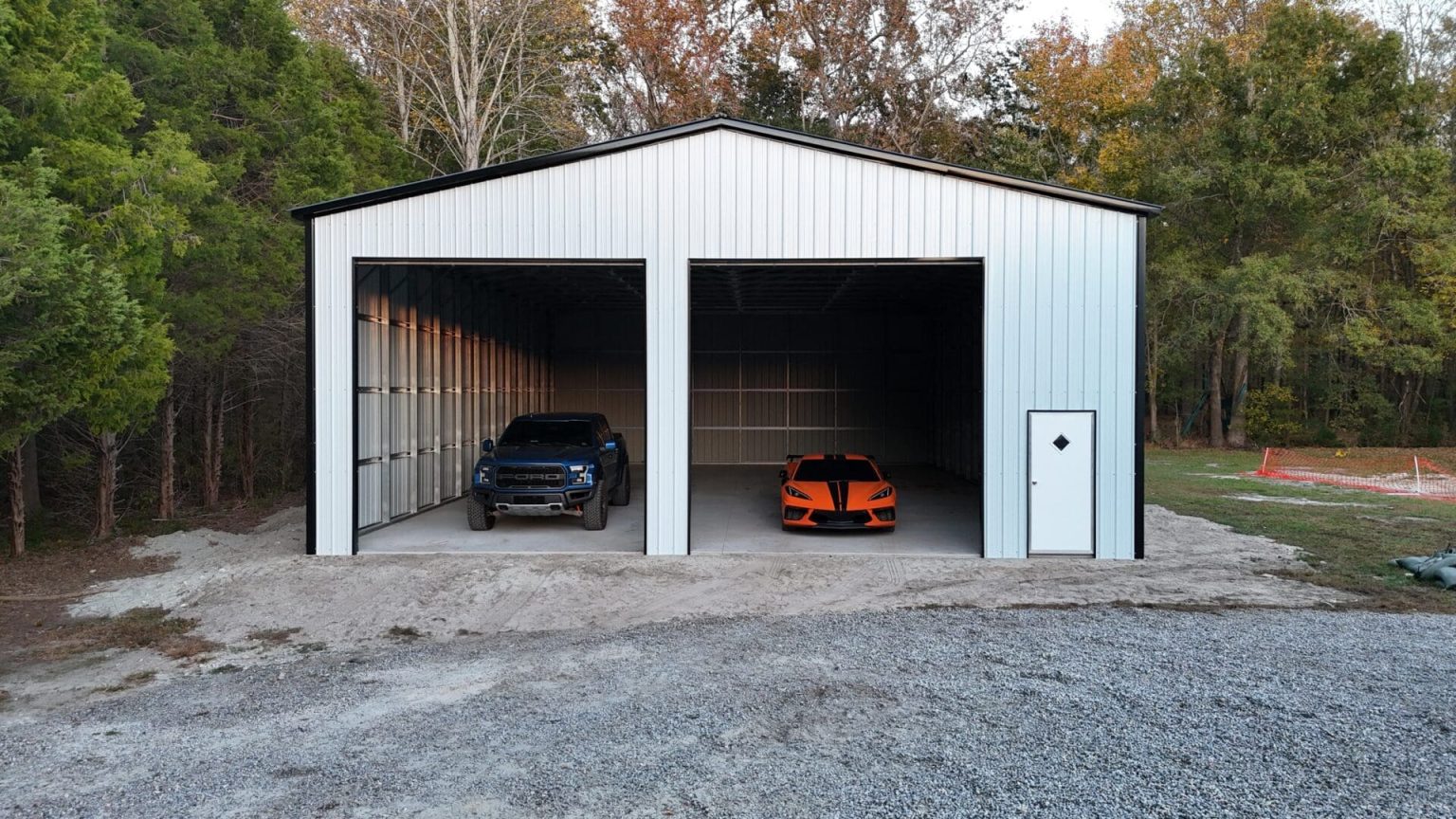 Two cars parked in a white garage.